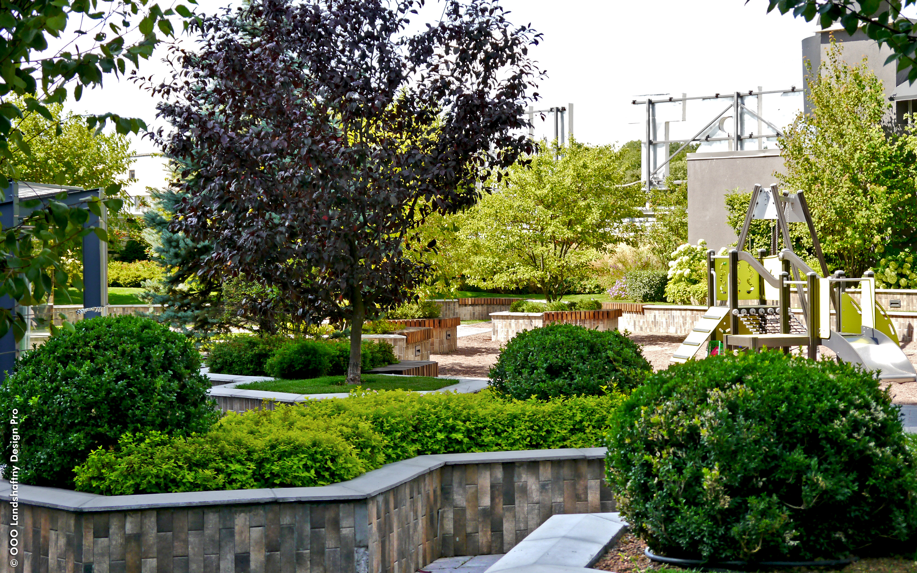 Roof garden with small trees, lawn and a playground